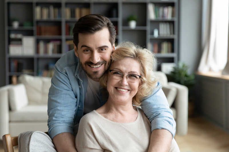 happy young man with old woman