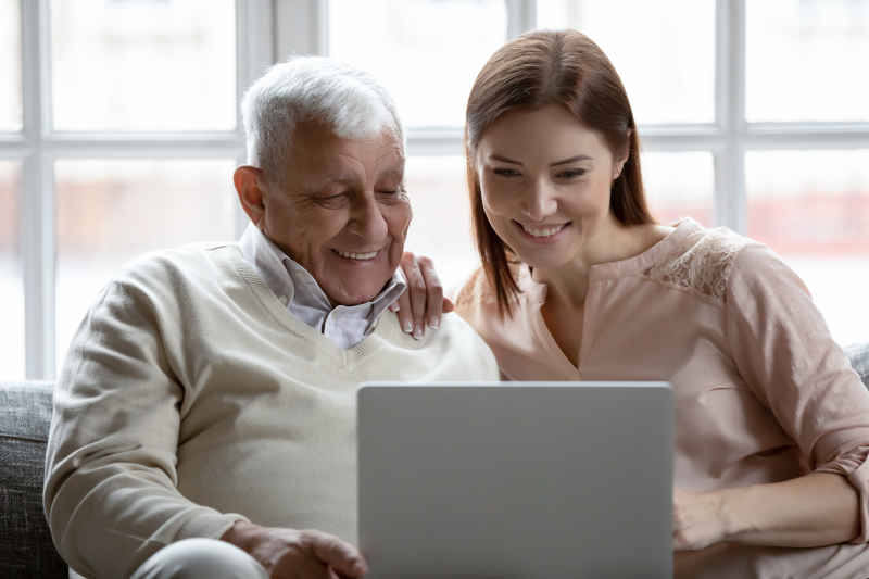 young woman and old man with laptop